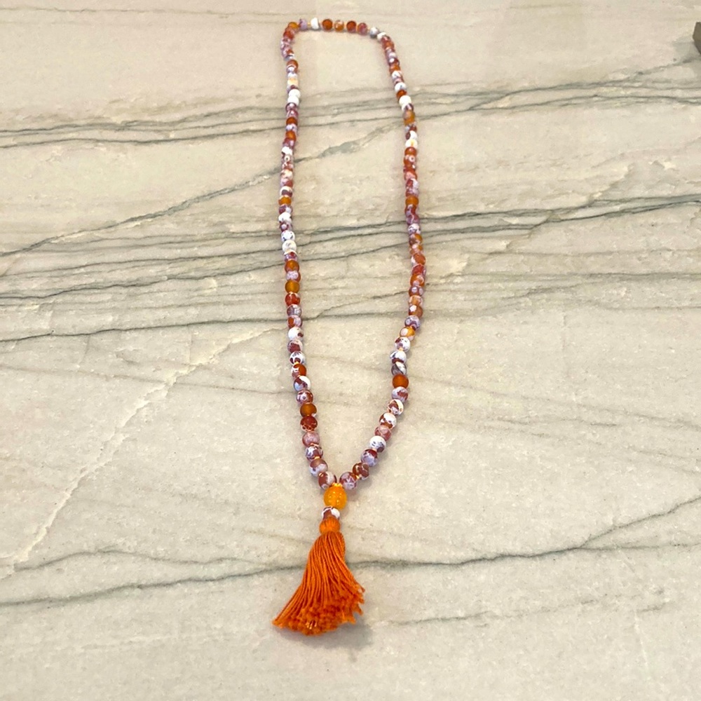 Orange and white glass bead necklace with tassel